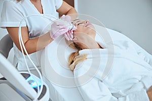 Blonde woman getting a skin tightening treatment