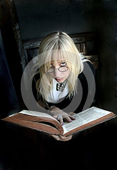 blonde woman with glasses and old book