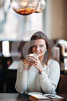 Blonde woman holding cup of coffee