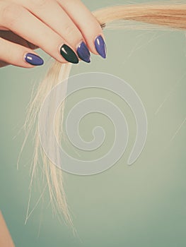 Blonde woman holding her hair ends