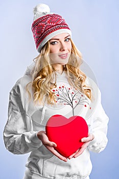 Blonde woman holding a red heart. Valentine`s day