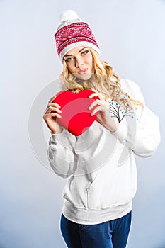 Blonde woman holding a red heart. Valentines day