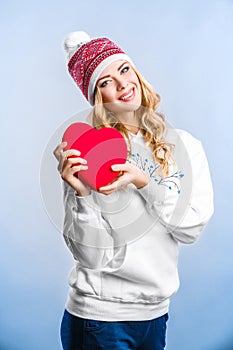 Blonde woman holding a red heart. Valentines day