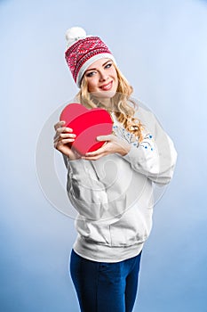 Blonde woman holding a red heart. Valentines day