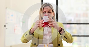 Blonde woman lifts toy rocket launching above money stack