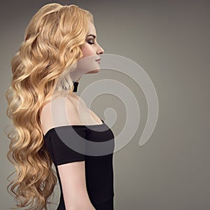 Blonde woman with long curly beautiful hair.