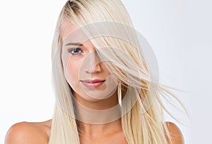 Blonde woman, long hair and studio portrait with beauty, wellness and results by white background. Girl, person and