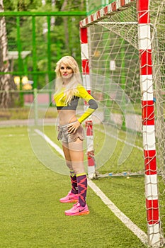 Blonde woman with long hair in top with ball on