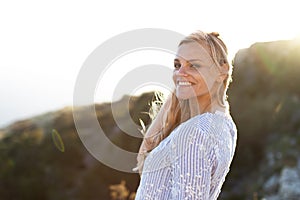 Blonde woman looking back outdoors