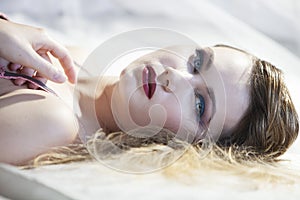 Blonde woman lying and looking