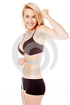 Blonde woman measuring her stomache