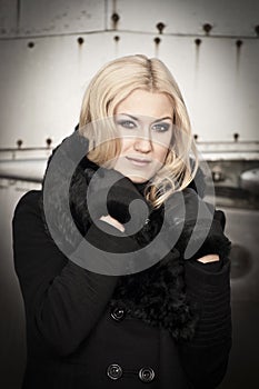 Blonde woman posing with warm clothes