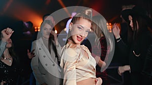 Blonde woman professional dancer choreography dancing at nightclub party evening festive discotheque