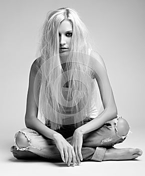 Blonde woman in ragged jeans and vest