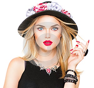 blonde woman with red lips and manicure in modern black hat