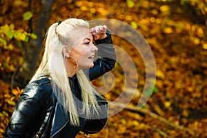 Blonde woman relaxing in autumn park