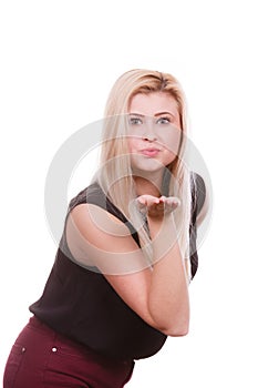 Blonde woman sending air kiss on palm hand