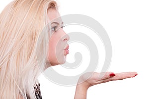 Blonde woman sending air kiss on palm hand