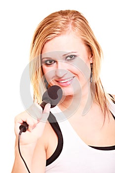 Blonde woman singing to microphone