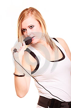 Blonde woman singing to microphone