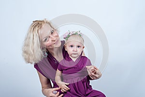Blonde woman with a small daughter in matching dresses