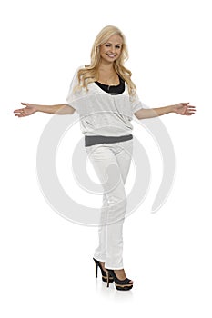 Blonde woman standing arms wide open