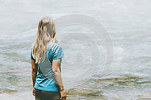 Blonde woman standing at river alone Lifestyle travel