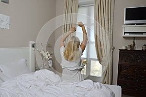 Blonde Woman Stretching in Bedchamber