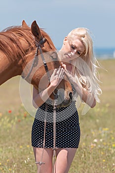 Blonde woman stroking gelding