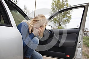 Nausea during a car trip. A blonde woman suffers from kinetosis. The concept of motion sickness in diseases of the transport and photo