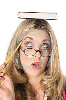 Blonde woman thinking with book on head