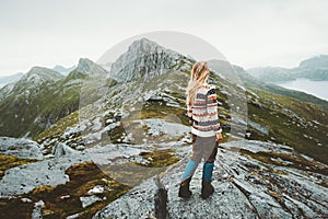 Blonde woman walking in scandinavian mountains