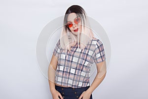 Blonde woman wearing sunglasses over white background