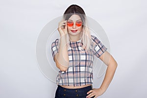 Blonde woman wearing sunglasses over white background