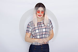 Blonde woman wearing sunglasses over white background