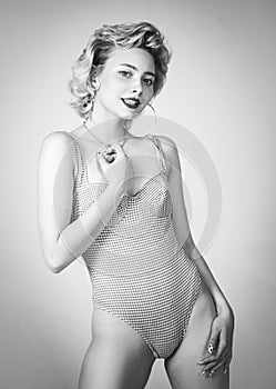 Blonde woman wearing swimsuit in pinup pose. Beautiful Woman in swimsuit, retro blonde girl, beauty fashion woman