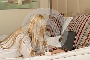 Blonde woman working from home on laptop, solitude and remote work concept