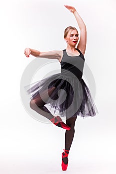 Blonde young beautiful ballet dancer isolated over white background.