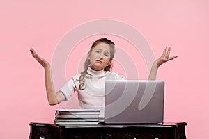 Blonde young girl in a white shirt and spreads her arms apart from hopelessness