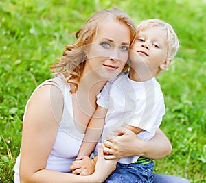 Blonde young MOther ans son playing in the park. photo