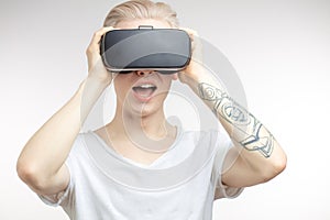 Blonde Man getting experience using VR headset glasses of virtual reality