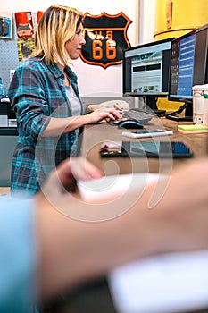 Blonde young woman checking orders received by ecommerce shop