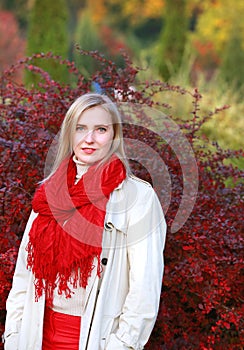 Blonde young woman walk in autumn park