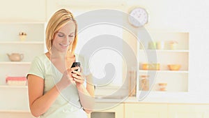 Blondhaired woman sending text messages