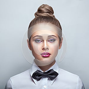 Blondie woman in white shirt and black bow-tie