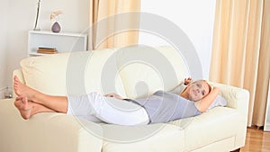 Blone woman lying on a sofa