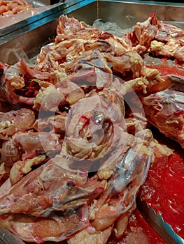 Blood bleeding fresh chicken frame in supermarket for sale,Pile up on ice color pink and red