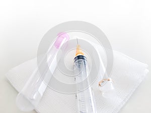 Blood collection tube and syringe  with gauze in healthcare check up concept,selective focus