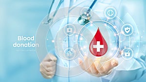 Blood Donation concept. World blood donor day awareness. Doctor holding in hand drop of blood with medical cross icon and medicine