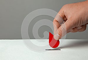 Blood donor. Man puts drop of blood in the piggy bank as donation. Concept donate blood save life. Copy space for text.